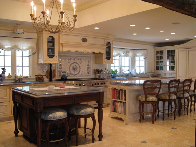 Designs by Dolores - Large kitchen with designed tile as stove backsplash