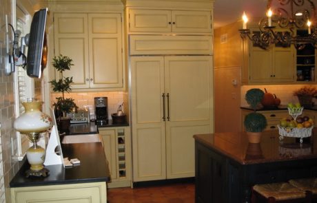 Designs by Dolores - Creme kitchen cabinetry with built in fridge