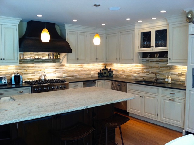 Designs by Dolores - White kitchen cabinetry with tiled backsplash