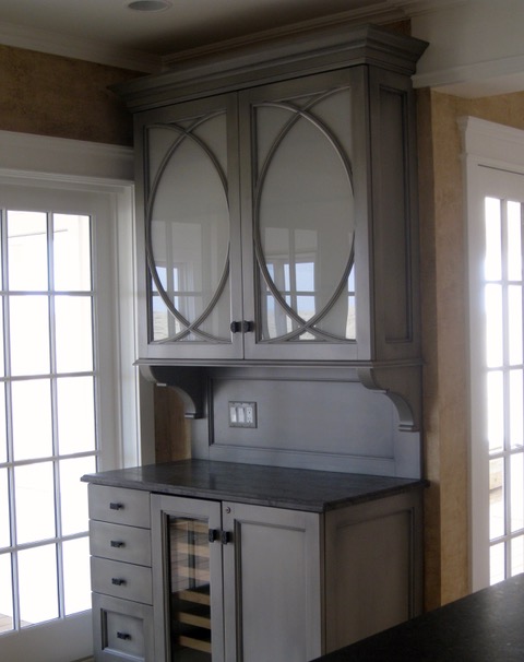 Designs by Dolores - Corner cabinetry for showcasing wine and china pieces