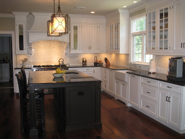 Designs by Dolores - White cabinet kitchen with large dark center island