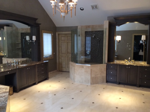 Designs by Dolores - Large Bathroom with dark cabinetry and light floors and tiling