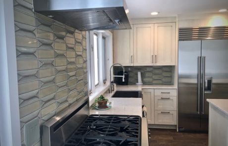 Designs by Dolores - Grey Backsplash with White Cabinets and Steel Appliances