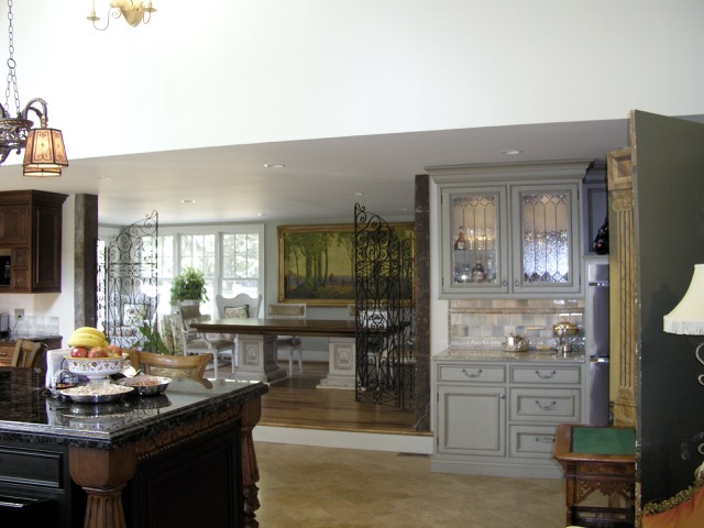 Designs by Dolores - Open kitchen with mixture of dark and light cabinetry