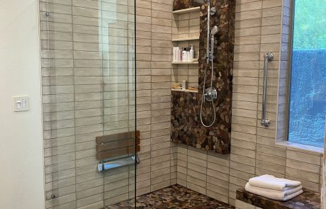 Bathroom remodel featuring cork, stand up shower and light tile.