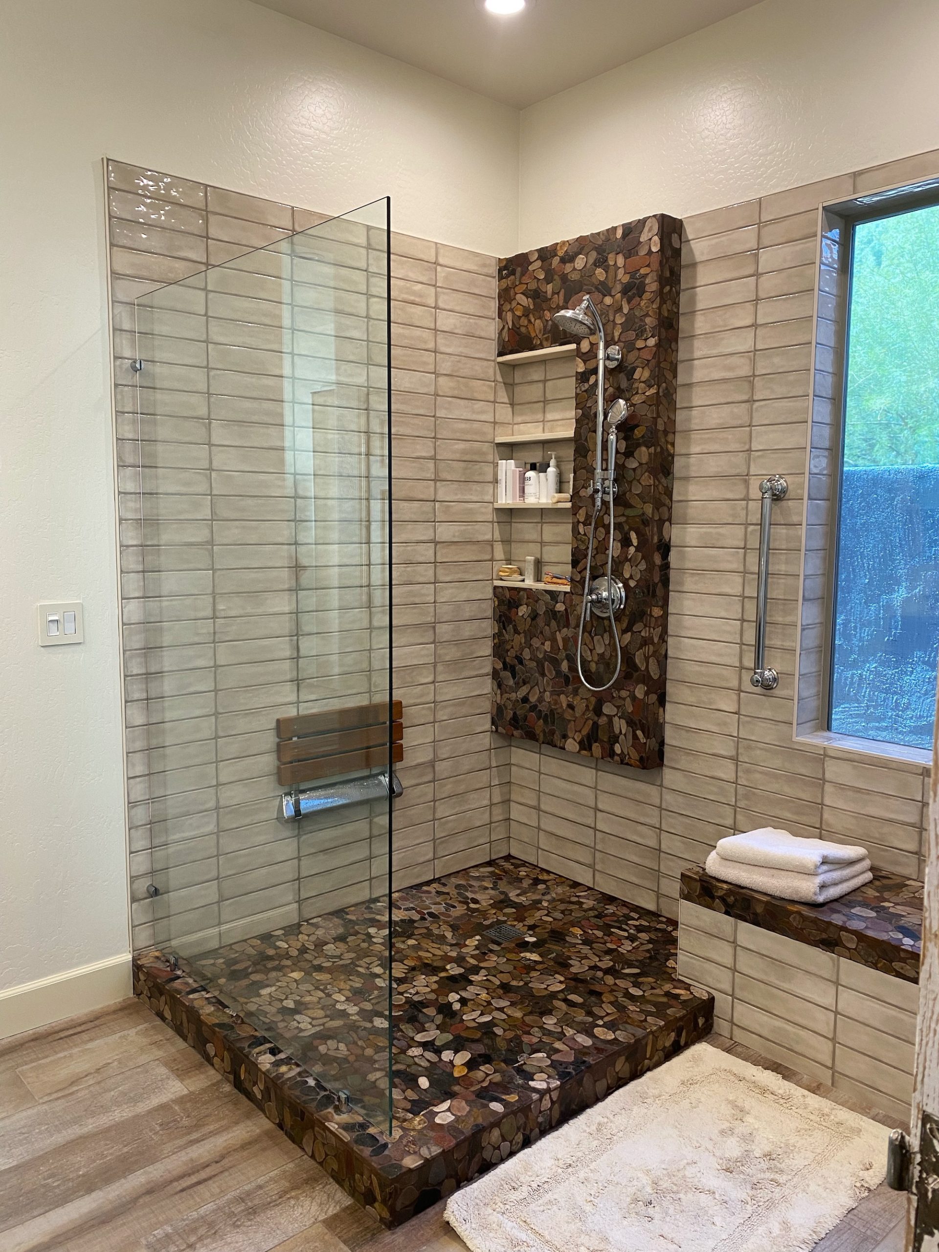 Bathroom remodel featuring cork, stand up shower and light tile.